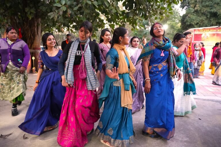 Devotees dancing and chanting Hare Krishna in kirtan