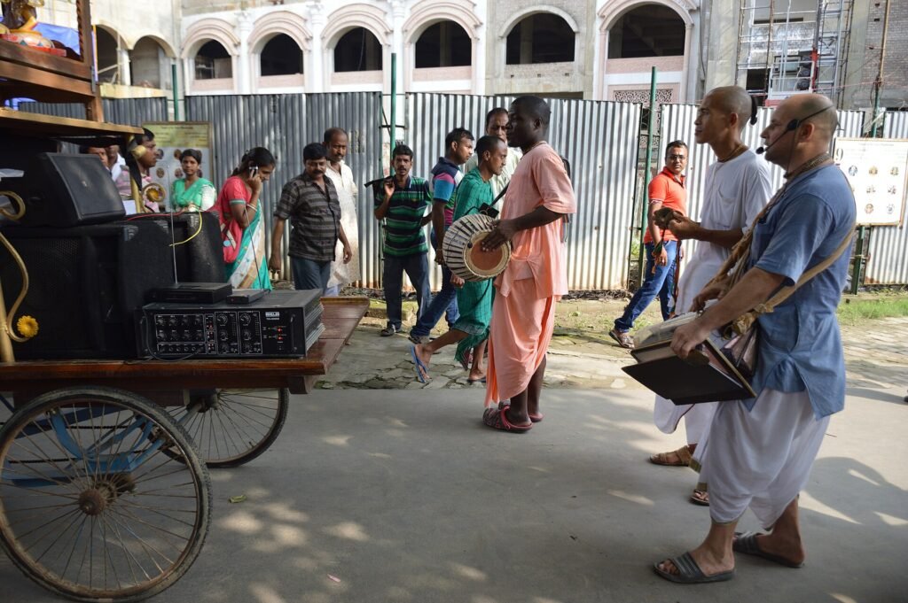 Devotee playing mridanga drum during street kirtan at ISKCON Mayapur